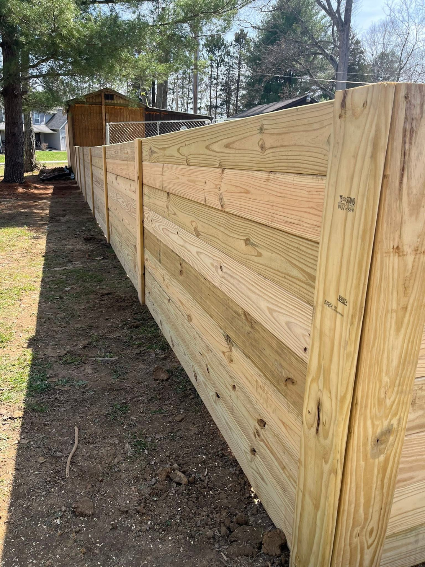Horizontal treated wood privacy fence